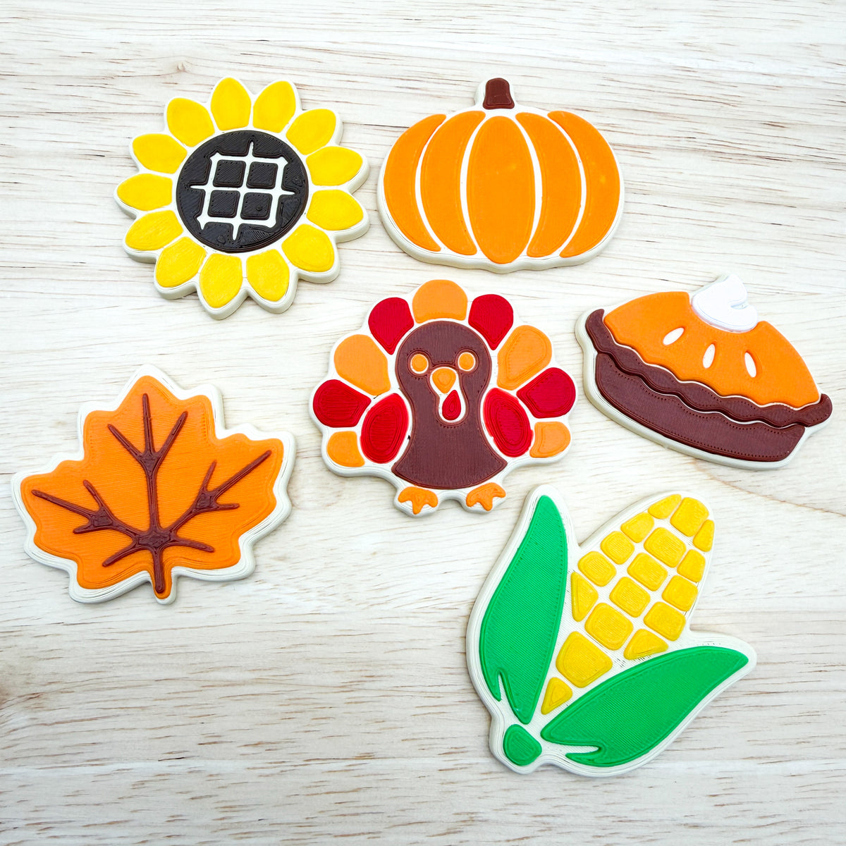 Six 3D printed fall cookies: sunflower, pumpkin, turkey, pumpkin pie, autumn leaf and corn on the cob