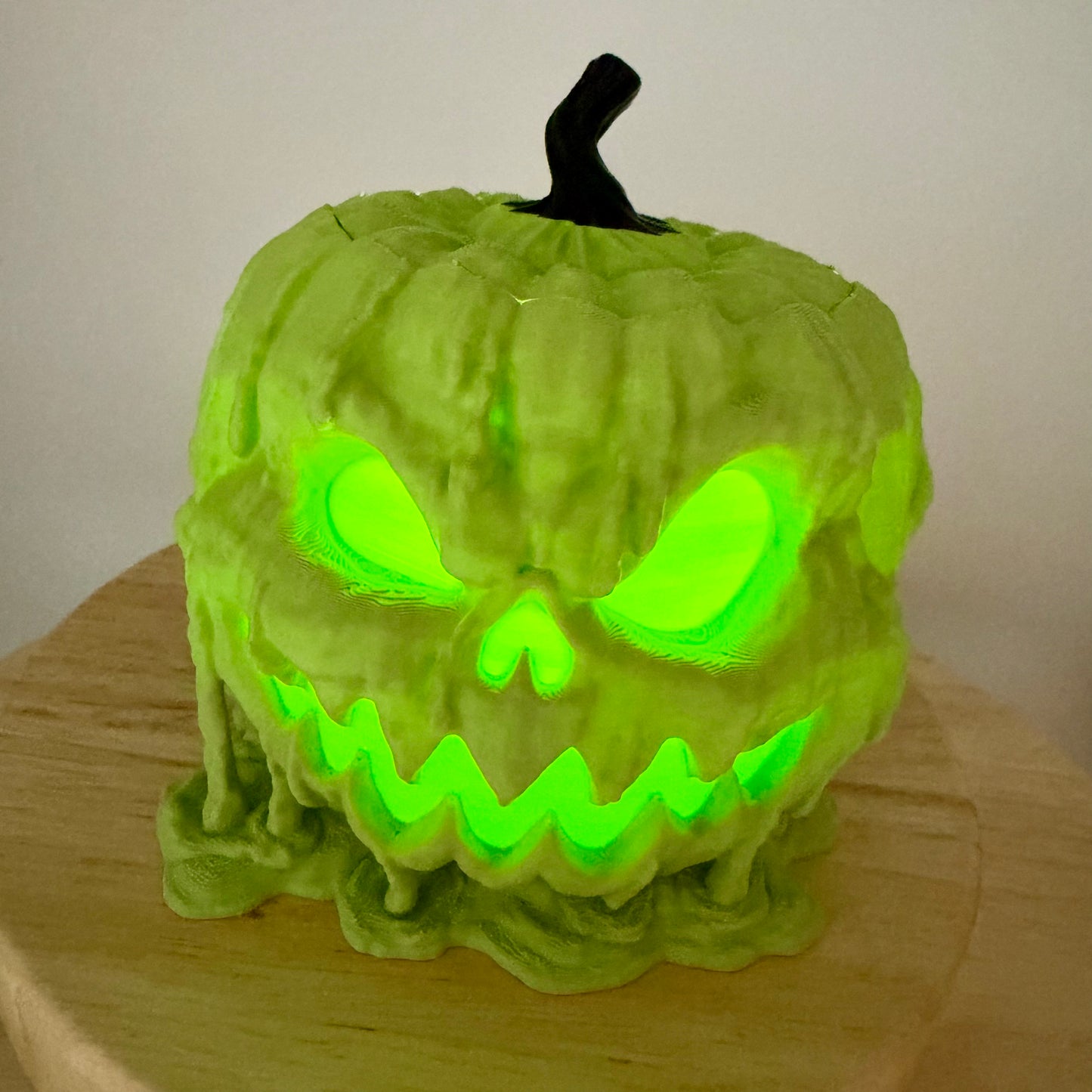 Melting jack-o'-lantern glowing lime green